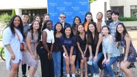 Group of 18 IHN alumni pose for a photo outdoors